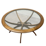 Load image into Gallery viewer, Round wooden coffee table with glass top on a white background
