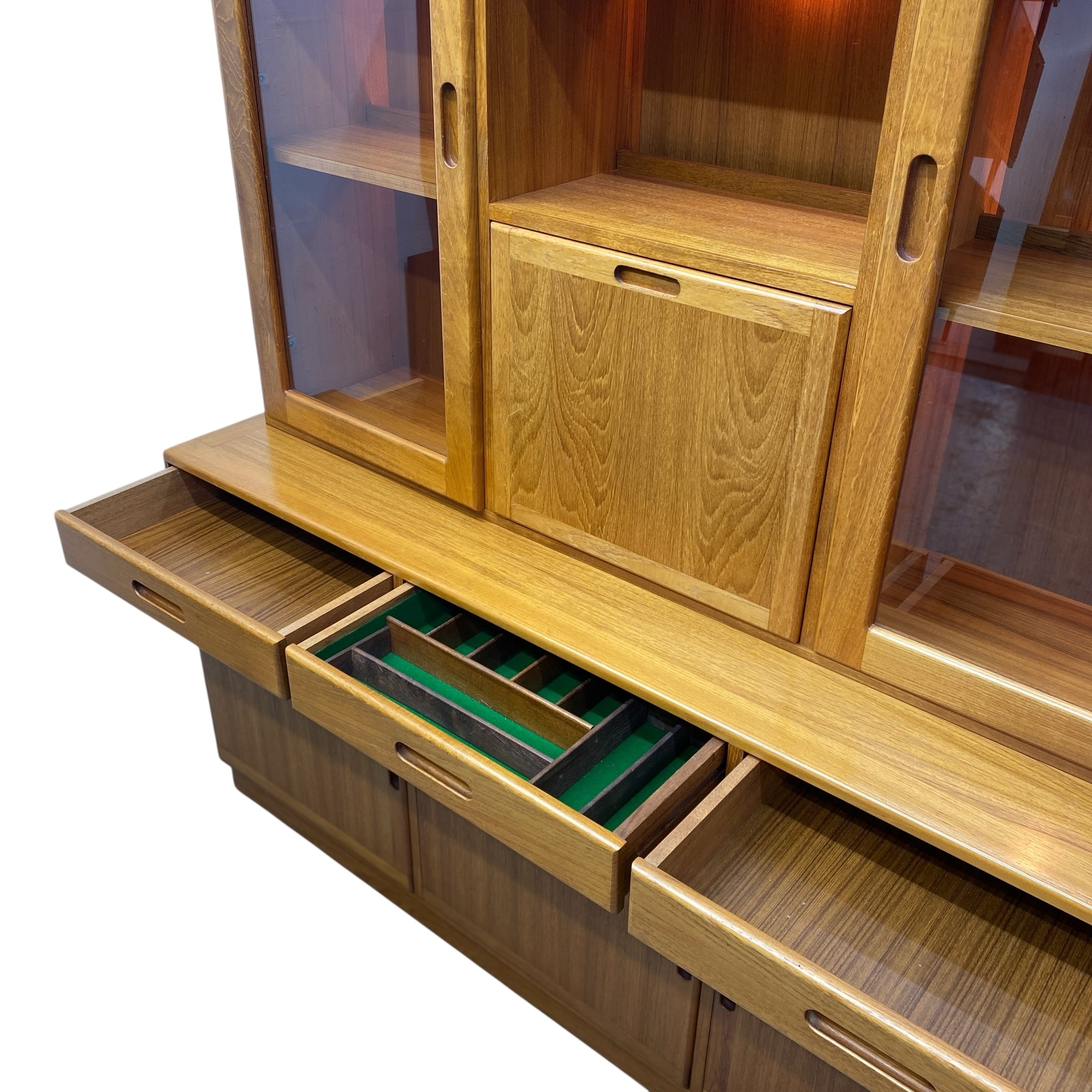 Wooden cabinet with open drawers and glass panels on a white background