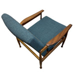 Load image into Gallery viewer, Wooden chair with blue cushion on a white background
