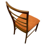 Load image into Gallery viewer, Wooden chair with orange cushion on a white background
