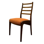 Load image into Gallery viewer, Chair with orange seat and wooden back on a white background

