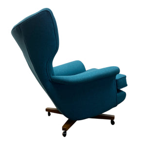 Blue armchair with wooden base on a white background