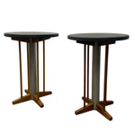 Load image into Gallery viewer, Two round tables with dark tops and wooden bases on a white background
