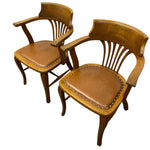 Load image into Gallery viewer, Two wooden chairs with brown leather seats on a white background
