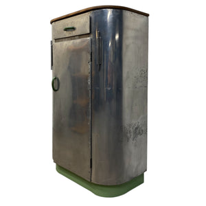 Metallic cylindrical object with a green base on a white background