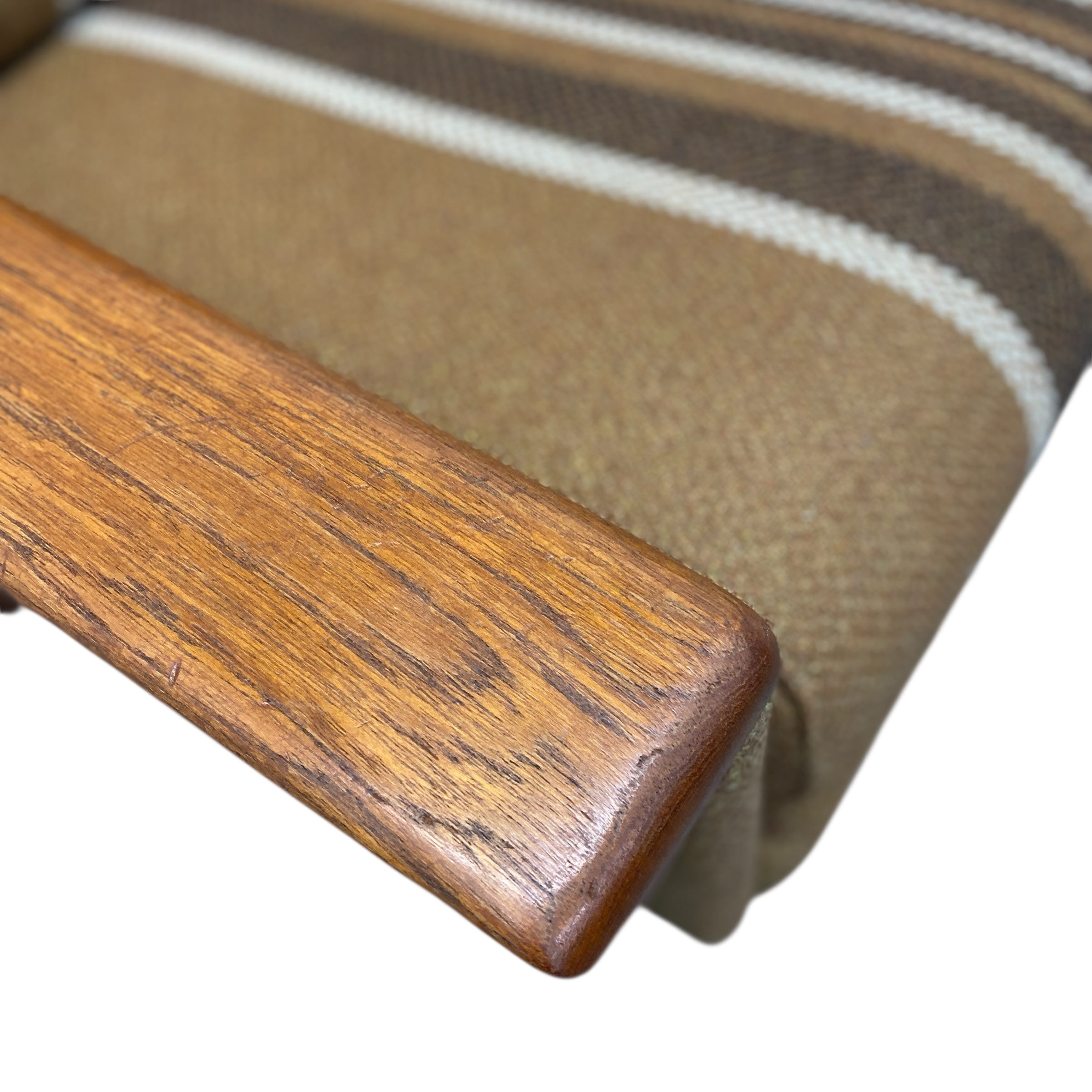 Close-up of a wooden handle on a striped fabric background
