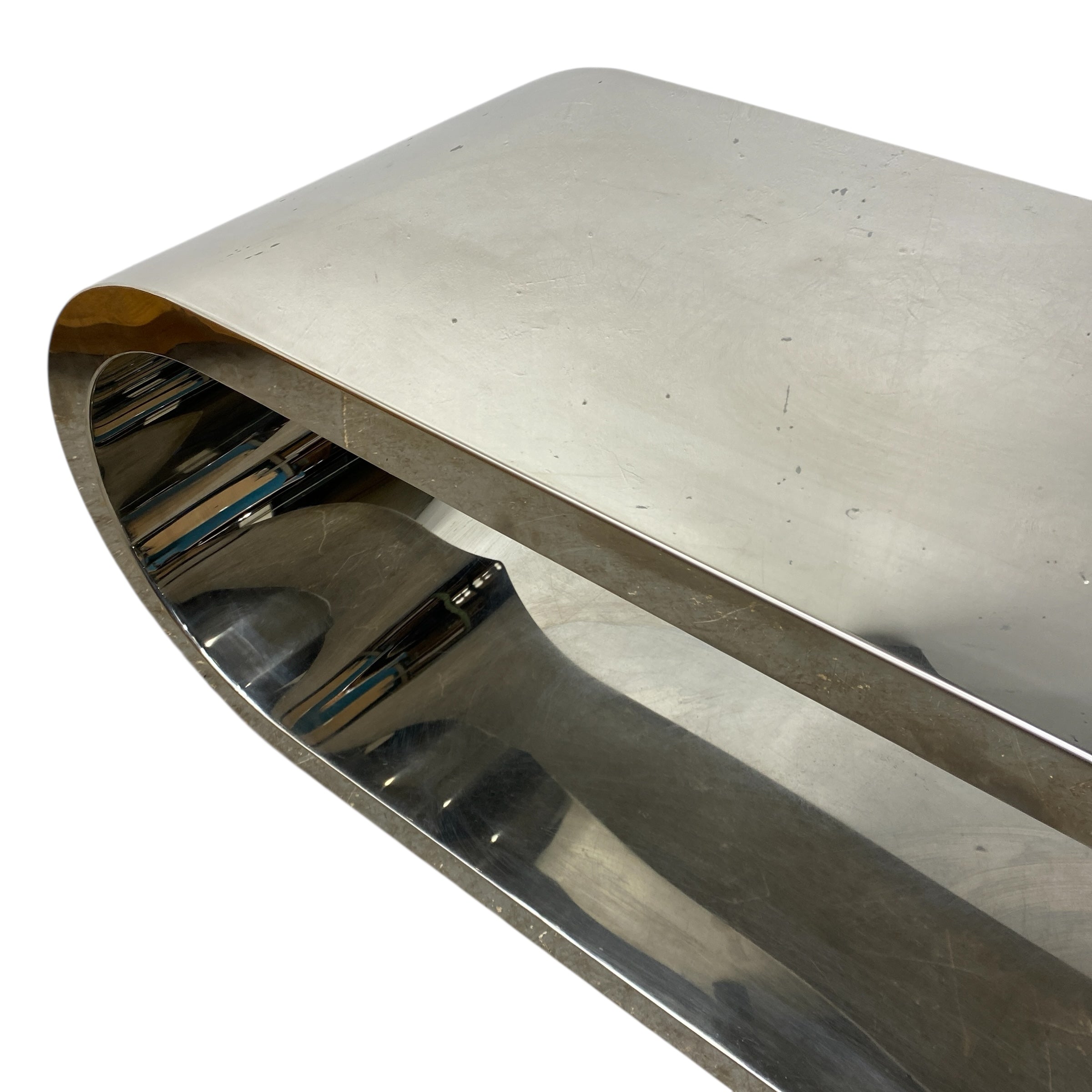 Metallic sculpture with a curved design on a white background