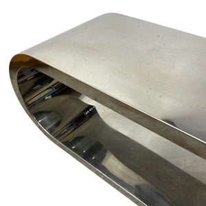 Metallic sculpture with a curved design on a white background