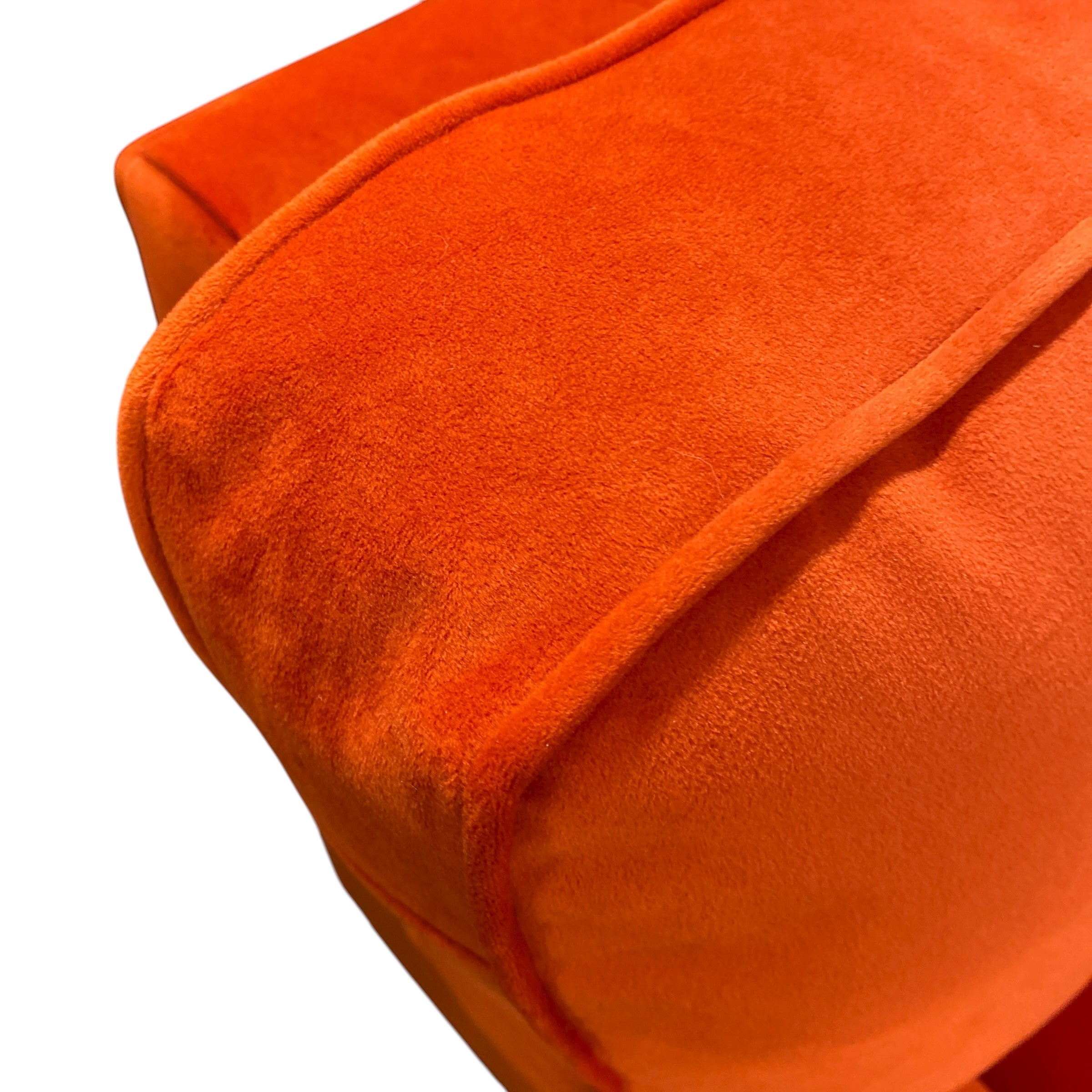 Close-up of an orange fabric surface with a subtle pattern