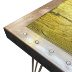 Load image into Gallery viewer, Close-up of a table corner with brass trim and yellow marble surface
