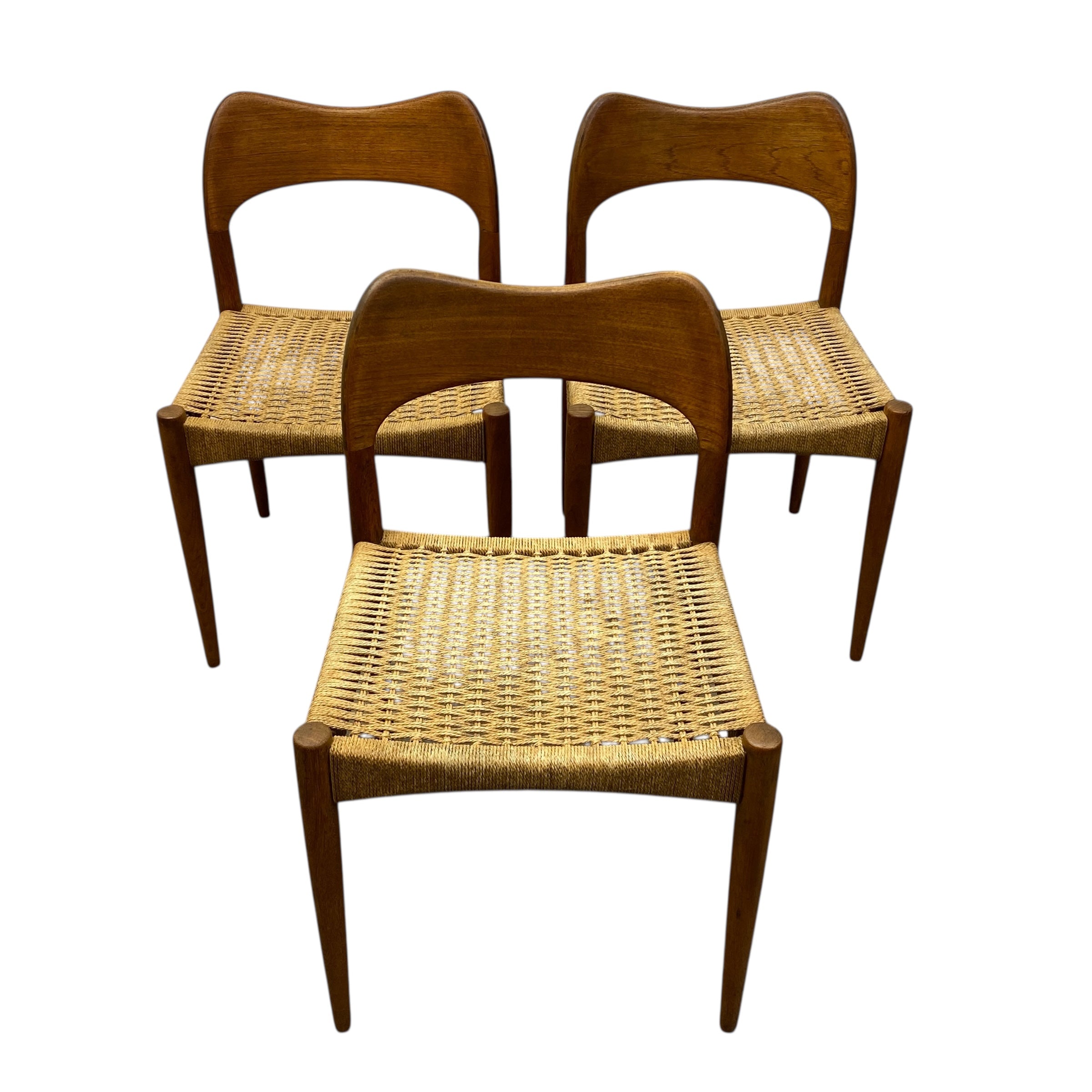 Three wooden chairs with wicker seats on a white background