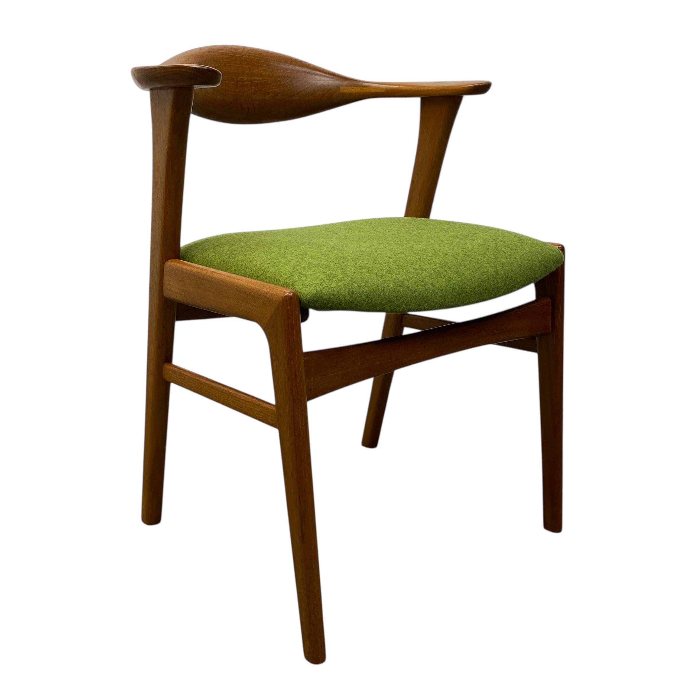 Wooden chair with a green cushion on a white background