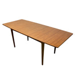Load image into Gallery viewer, Extended Wooden dining table with a white background

