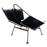 Load image into Gallery viewer, Modern black lounge chair with metal frame on a white background
