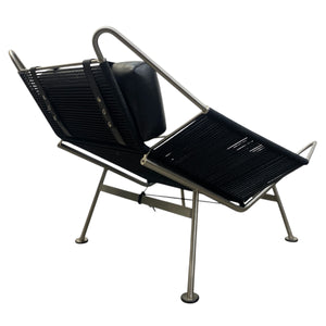 Modern black lounge chair with metal frame on a white background