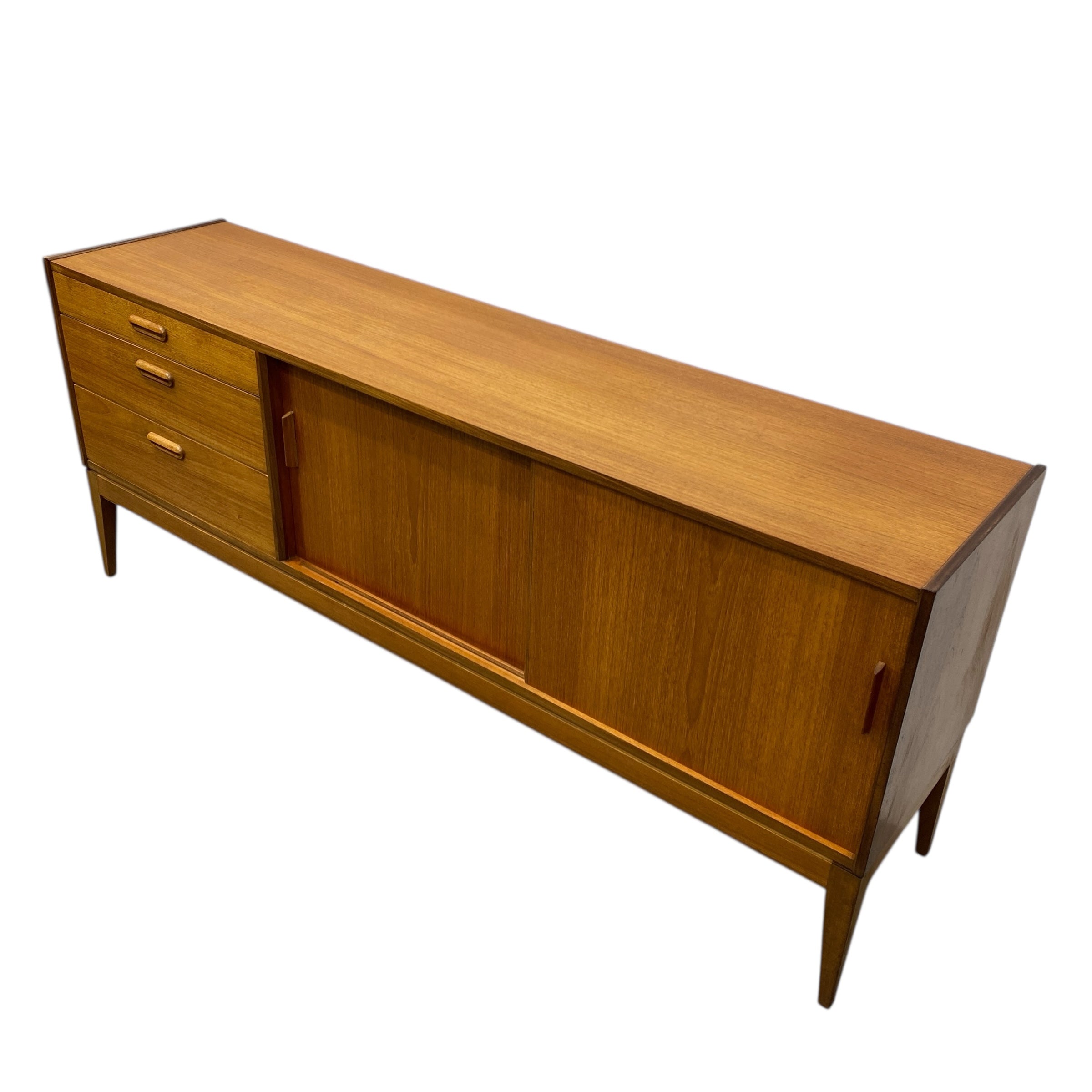 Wooden sideboard with drawers and a sliding door on a white background