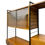Load image into Gallery viewer, Wooden shelf unit with glass panels and metal accents on a white background

