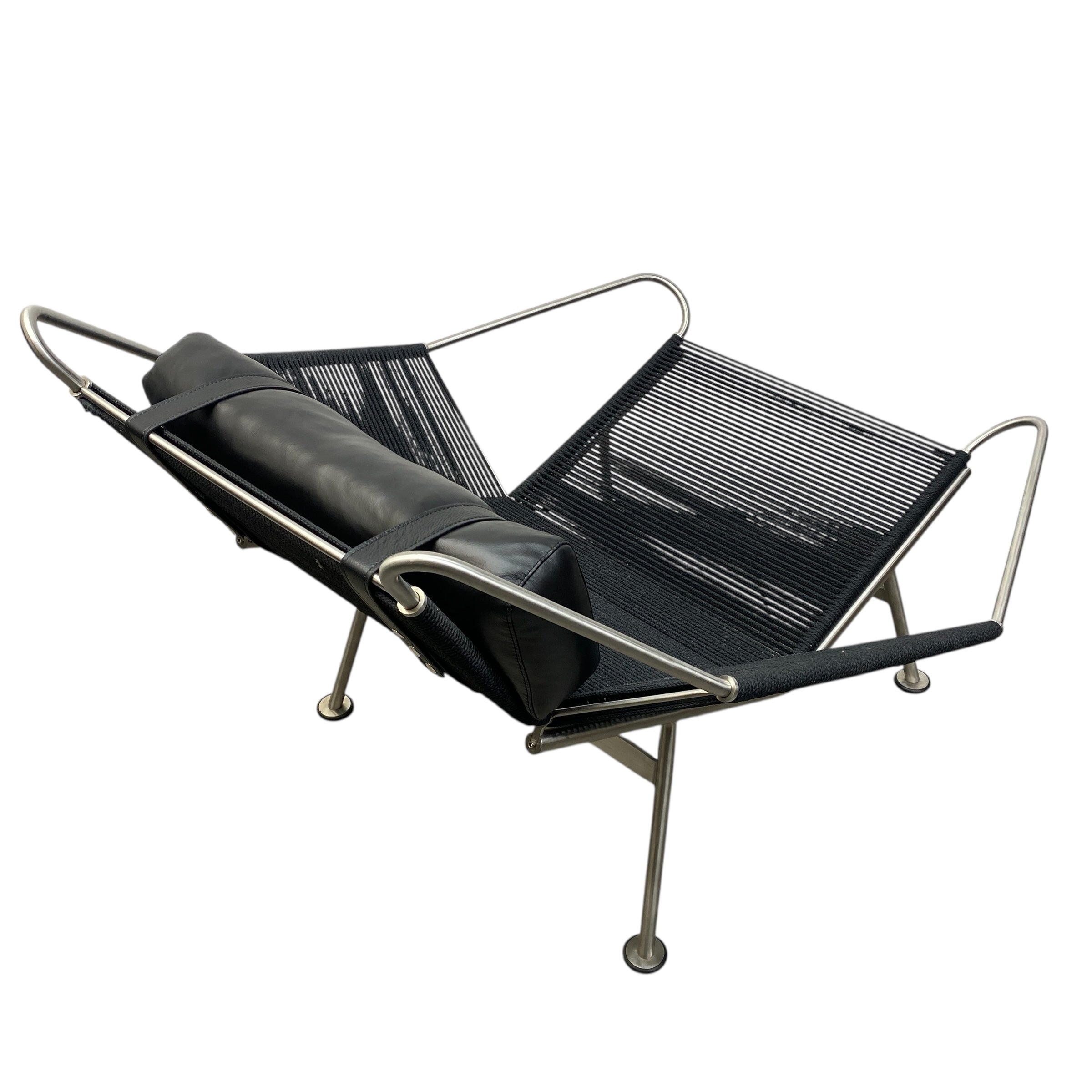 Modern lounge chair with black seat and mesh back on a white background