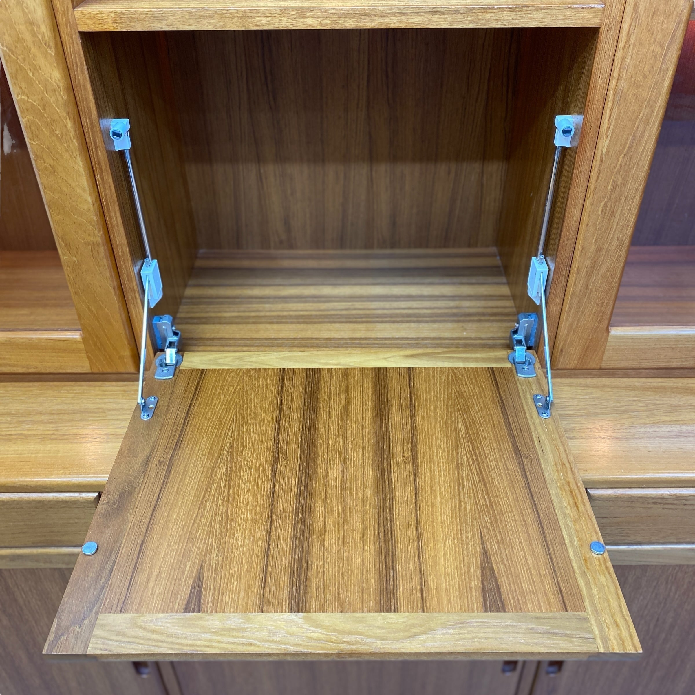 Wooden cabinet with open shelves and blue clamps holding them together.
