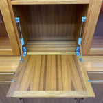 Load image into Gallery viewer, Wooden cabinet with open shelves and blue clamps holding them together.
