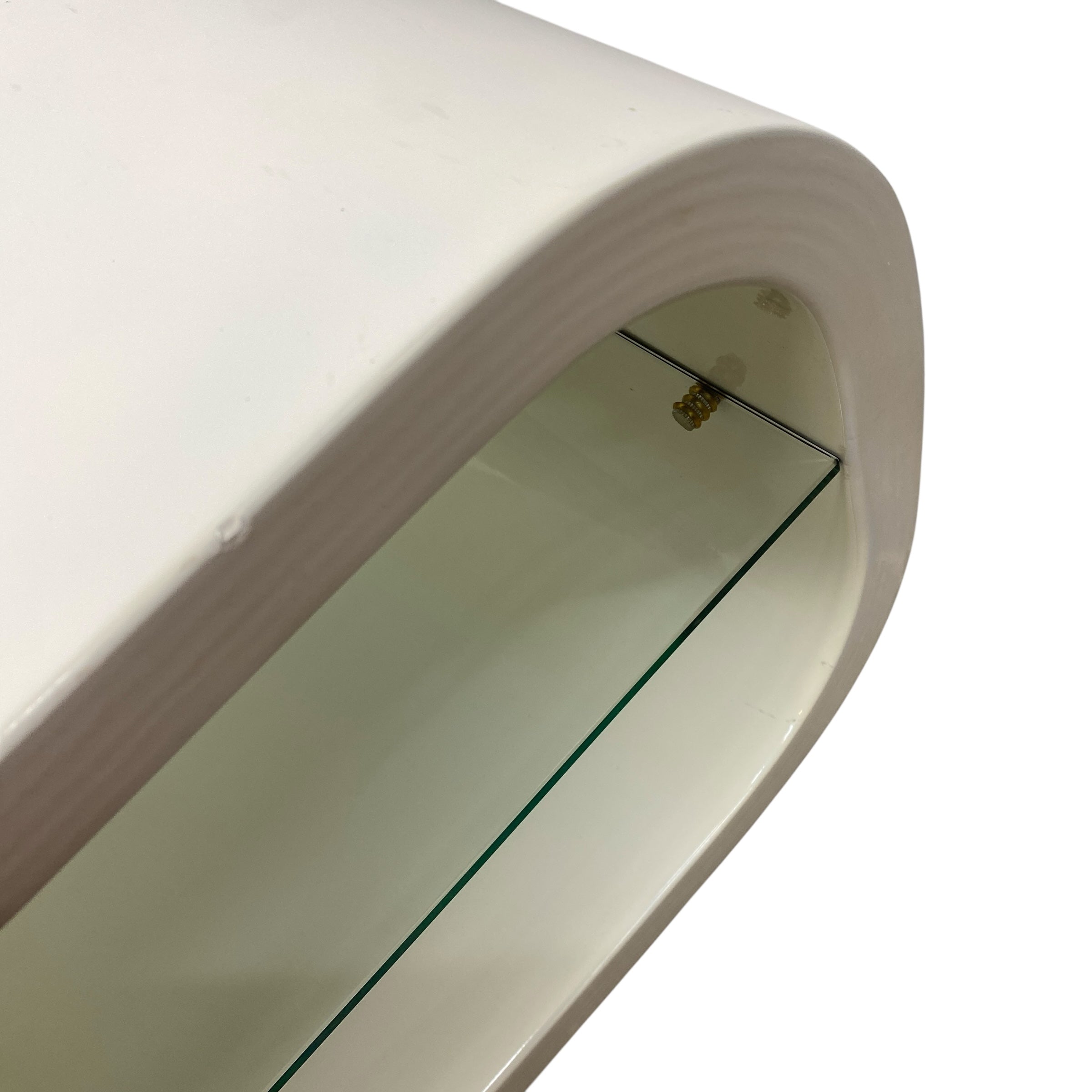 Curved white shelf with a glass bottom on a white background