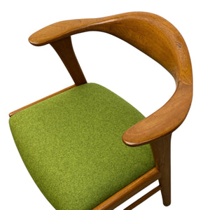 Chair with wooden armrests and green cushion on a white background