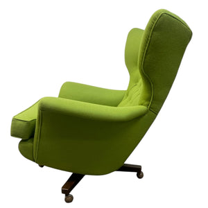 Green wingback chair on a white background