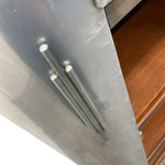 Load image into Gallery viewer, Metallic surface with cylindrical objects on a reflective background
