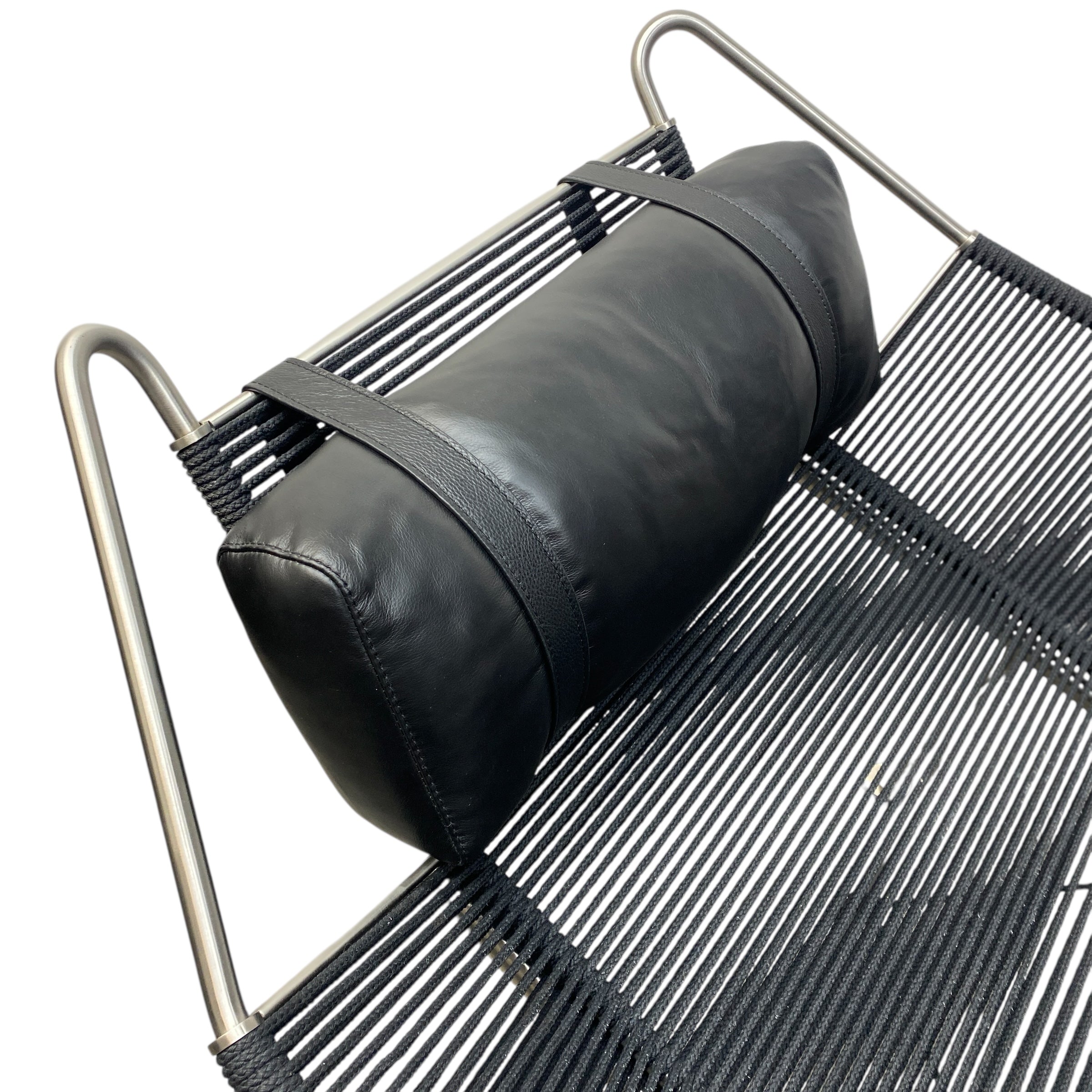Black bag on a metal chair with a white background