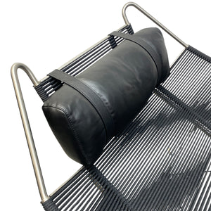 Black bag on a metal chair with a white background