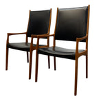 Load image into Gallery viewer, Two black chairs with wooden frames on a white background

