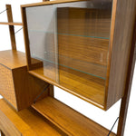 Load image into Gallery viewer, Wooden shelf unit with glass panels on a white background
