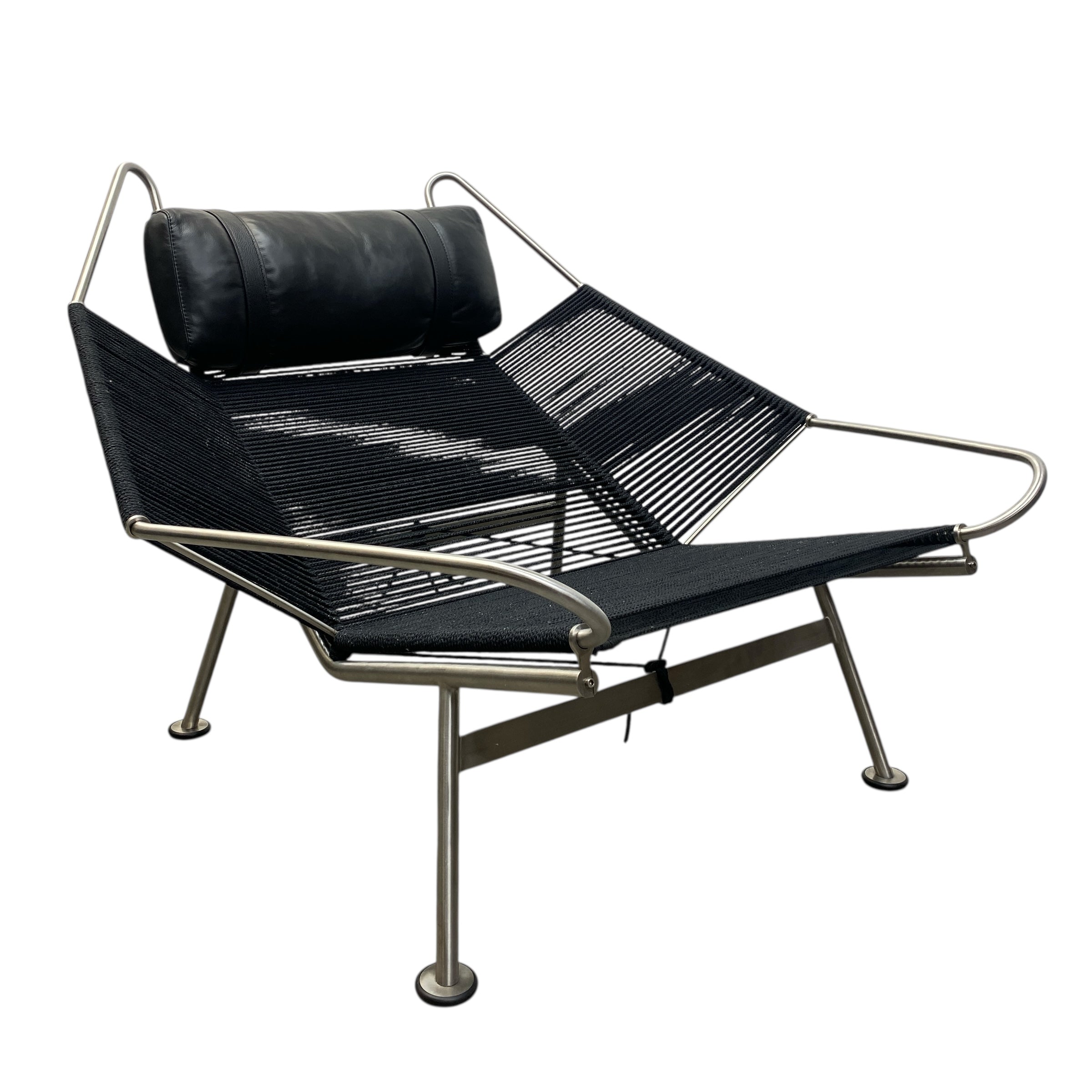 Modern lounge chair with black mesh seat and backrest on a white background