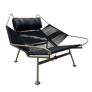 Modern lounge chair with black mesh seat and backrest on a white background