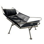 Load image into Gallery viewer, Modern lounge chair with black leather and metal frame on a white background
