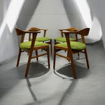 Load image into Gallery viewer, Wooden chairs with green cushions arranged in a circle on a gray floor.
