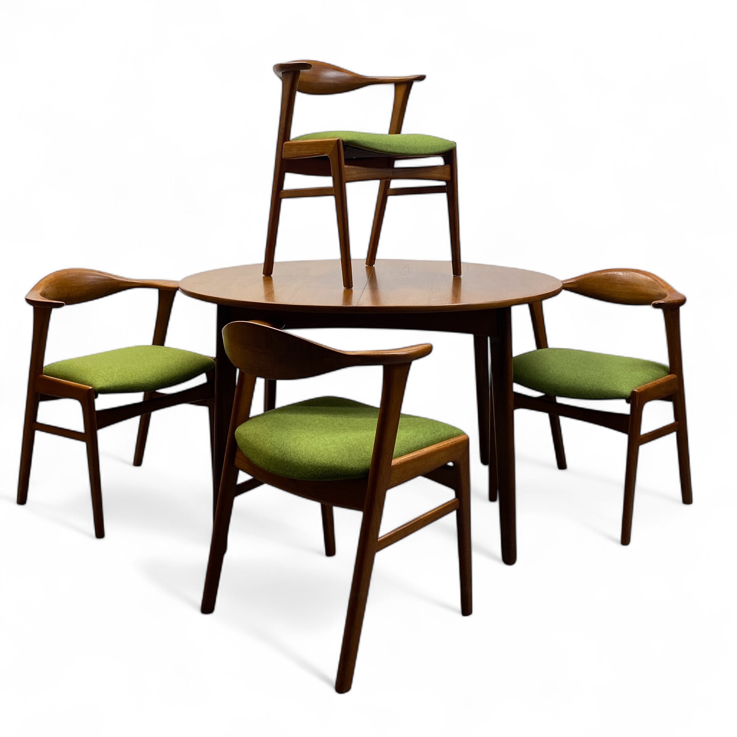 Dining table set with four chairs on a white background