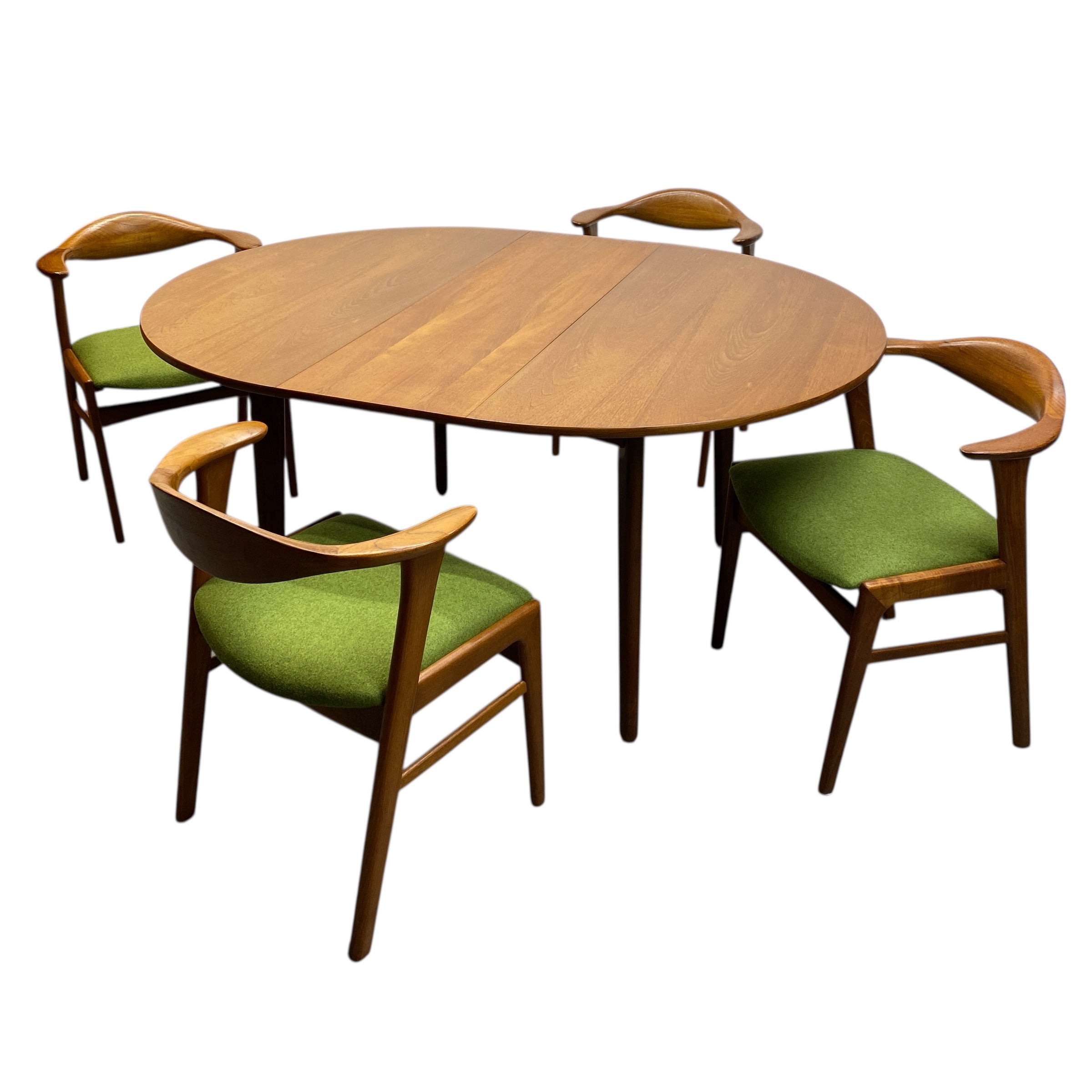 Danish Oval wooden table with four matching chairs on a white background
