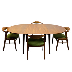 Danish Extended Wooden dining table with four matching chairs on a white background