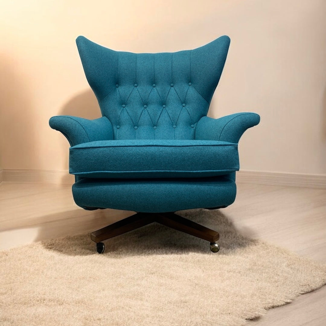 Blue armchair with tufted backrest on a beige carpet