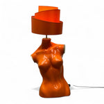Load image into Gallery viewer, Orange lamp shaped like a torso with a wavy design on a white background
