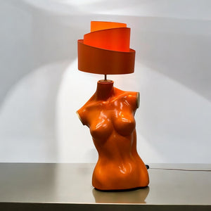 Vintage Orange lamp shaped like a female torso on a white background