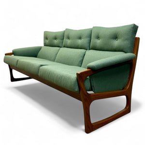 Green sofa with wooden frame on a white background