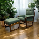 Load image into Gallery viewer, Chair and ottoman with green cushions on a wooden floor, surrounded by plants.
