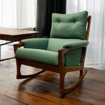 Load image into Gallery viewer, Green cushioned rocking chair on a wooden floor with curtains in the background
