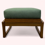 Load image into Gallery viewer, Wooden ottoman with a green cushion on a white background
