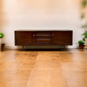 Wooden sideboard in a room with wooden floor and blurred background
