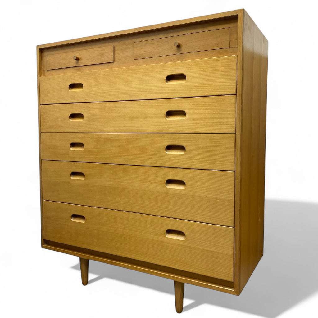 Wooden dresser with multiple drawers on a white background