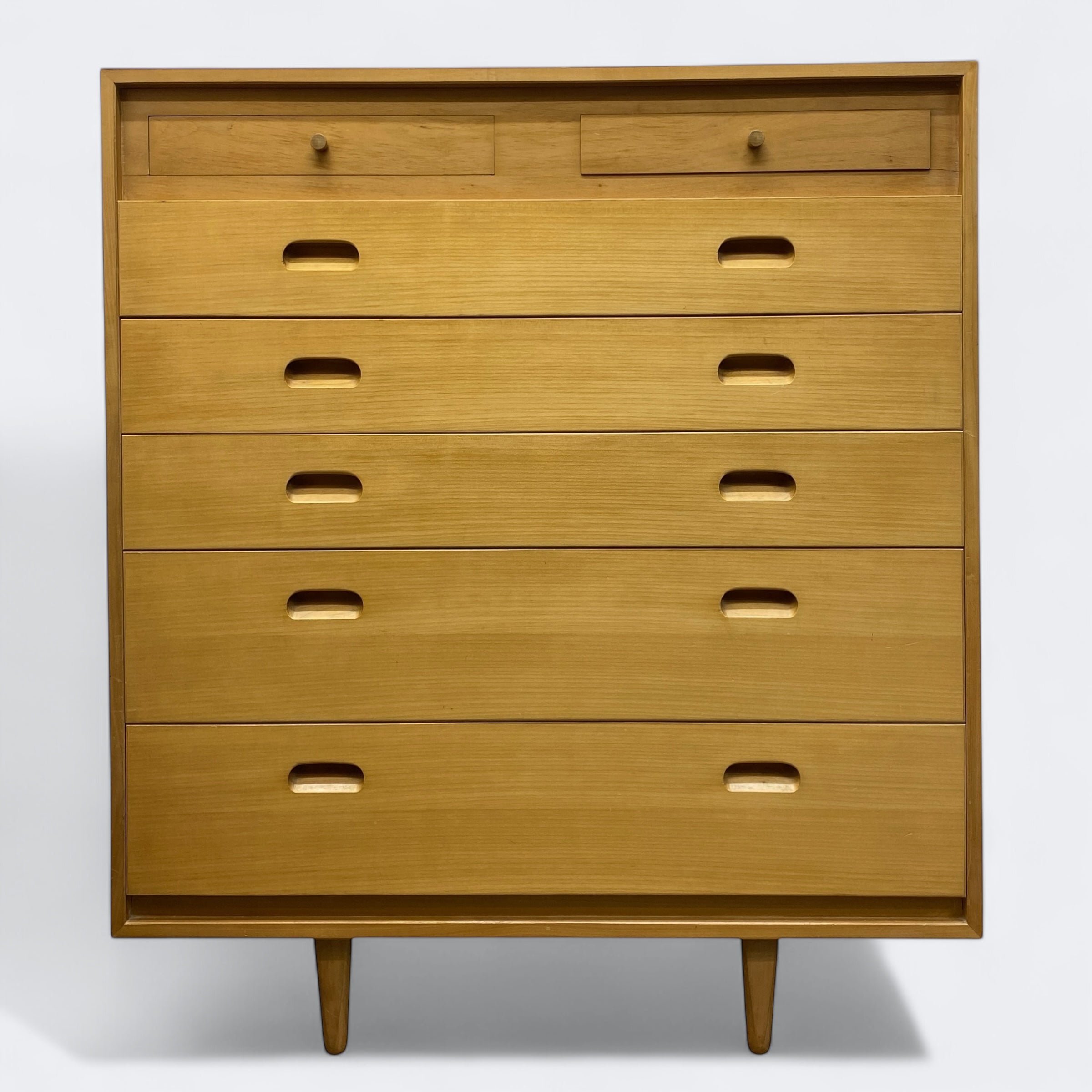 Wooden dresser with multiple drawers on a white background