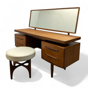 Wooden vanity with mirror and stool on a white background